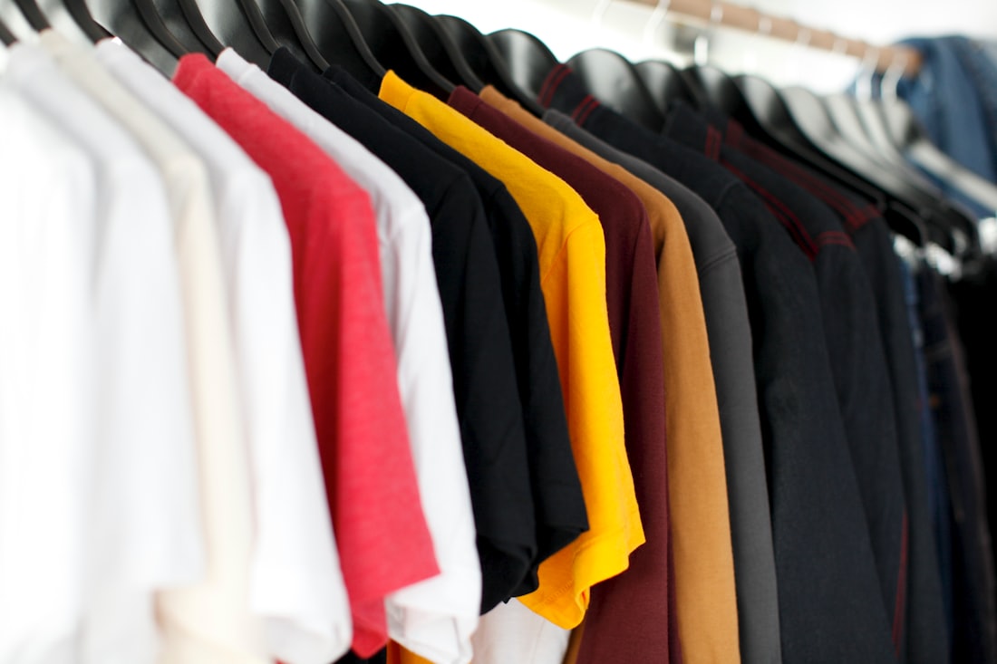 Branded apparel on rails in a stockroom