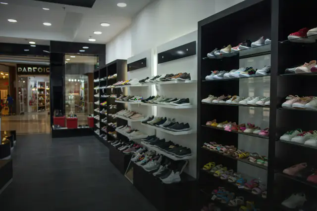 Shoe store wall with rows of sport and lifestyle shoes
